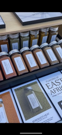 a display of spices in jars on a shelf